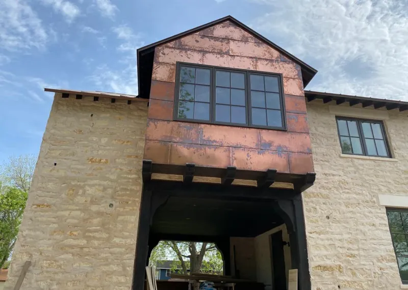 Copper metal panel facade on a stone building for Metal Roof Coating in Blakely