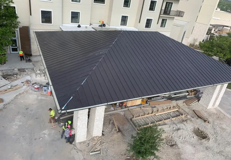 Metal roofing installation team working on a commercial building in Blakely